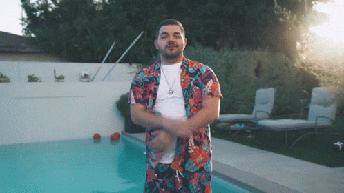 Man in Hawaiian Shirt in Front of Swimming Pool