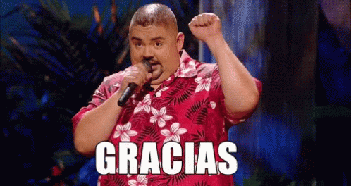 Man in Hawaiian Shirt Singing Into Microphone Gracias