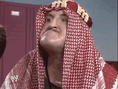 Man in Head Scarf and Keffiyeh Making a Face