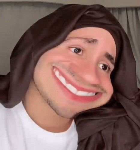 Man in Head Scarf Smiling and Making Face