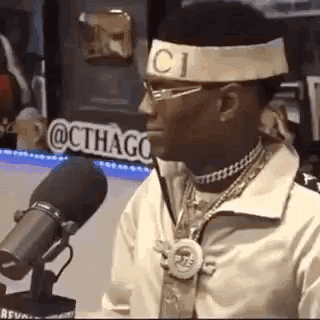 Man in Headband and Glasses Talking Into Microphone Saying No Twitter