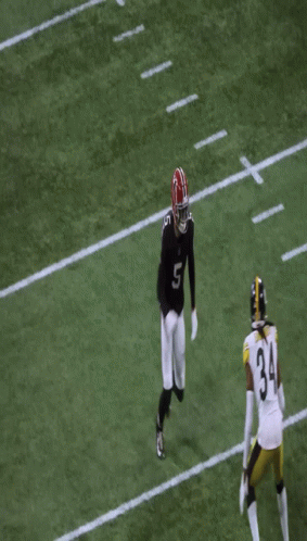 Man in Headband and Jersey Smiling at Game