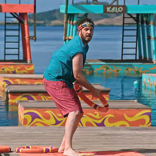 Man in Headband on Dock in Front of Kalo Sign