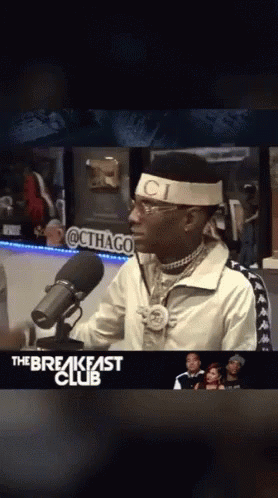 Man In Headband Saying Ci In Front Of Microphone GIF
