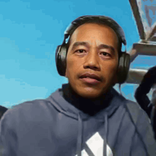 Man in Headphones and Adidas Hoodie