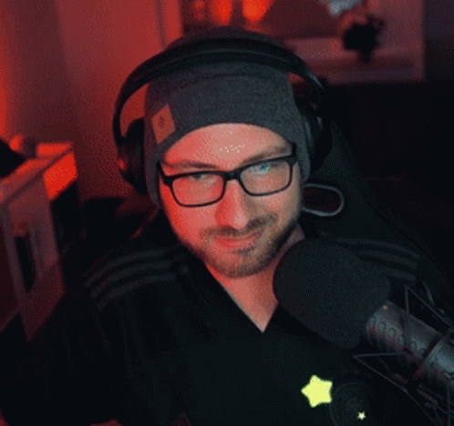 Man in Headphones and Beanie Thumbs Up
