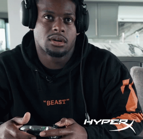 Man In Headphones And Beast Sweatshirt Holding Game Controller GIF