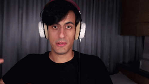 Man In Headphones And Black Shirt Looking At Camera GIF