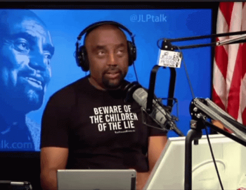 Man In Headphones And Black Shirt Saying Beware Of The Children Of The Lie GIF