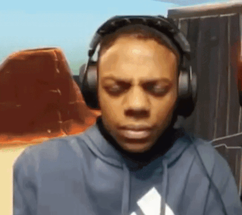 Man in Headphones and Blue Hoodie Looking Down