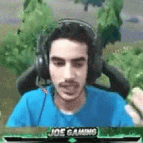 Man in Headphones and Blue Shirt With Joe Gaming
