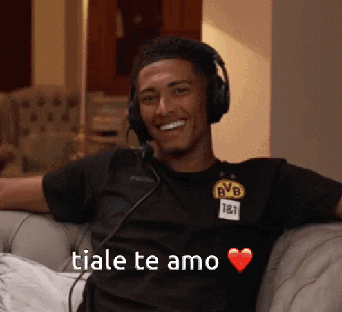 Man In Headphones And BVB Shirt Smiling On Couch GIF