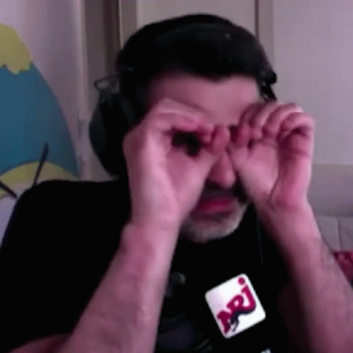 Man in Headphones and Glasses Covering Eyes