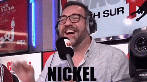Man in Headphones and Glasses Laughing at Microphone With Nickel