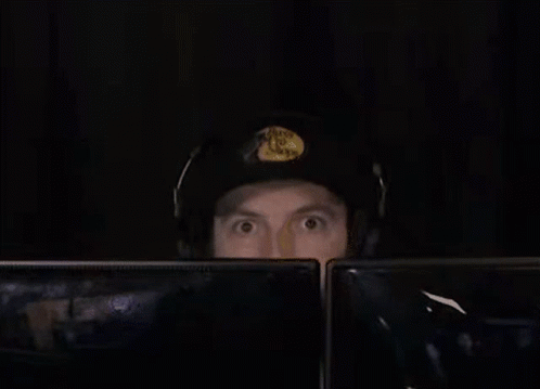 Man In Headphones And Hat At Two Monitors GIF