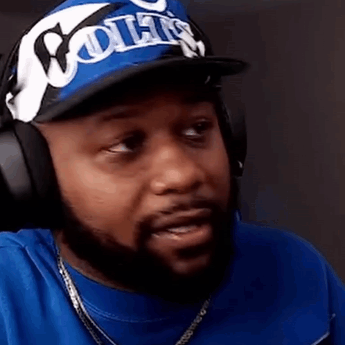Man in Headphones and Hat Making Funny Face