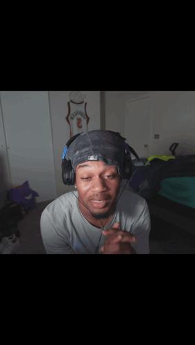 Man In Headphones And Hat With Number 3 GIF