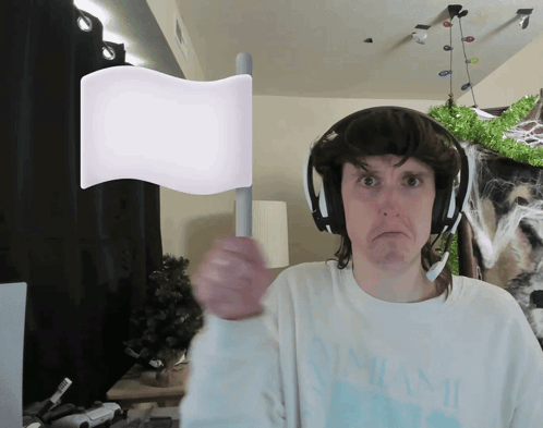 Man In Headphones And Miami Shirt Holding White Flag GIF