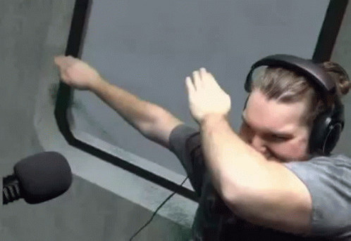 Man in Headphones and Microphone Doing Dab