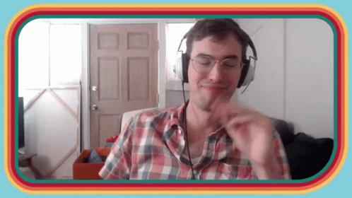 Man in Headphones and Plaid Shirt Making Face