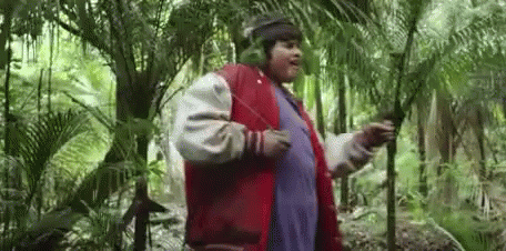 Man In Headphones And Red Jacket Standing In Woods GIF