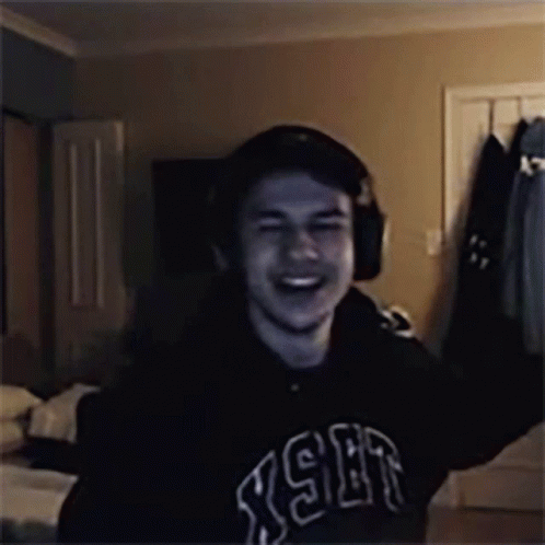 Man in Headphones and RSR Sweatshirt Laughing