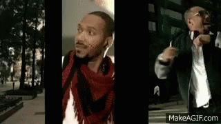 Man in Headphones and Scarf on Sidewalk