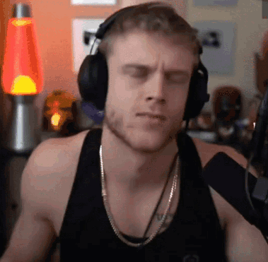 Man in Headphones and Tank Top Listening to Music