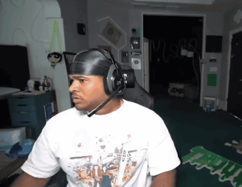 Man in Headphones and White Shirt Saying Mighty
