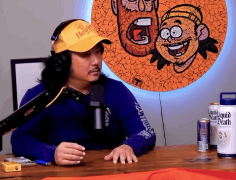 Man in Headphones and Yellow Hat with Liquid Death