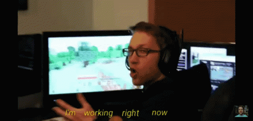 Man in Headphones Glasses Playing Video Game Says I'm Working Right Now