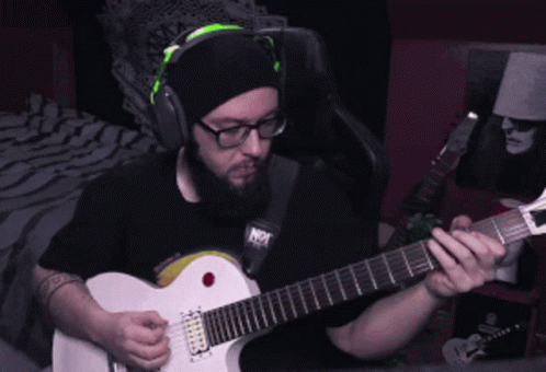 Man in Headphones Playing Guitar Saying Not