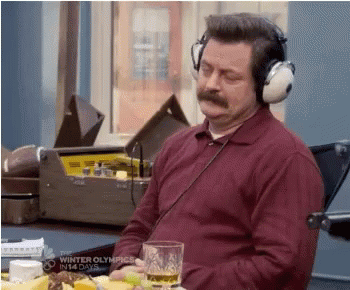 Man In Headphones Sitting At Table With Beer GIF