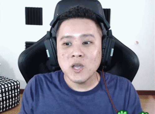 Man in Headphones Sitting in Gaming Chair