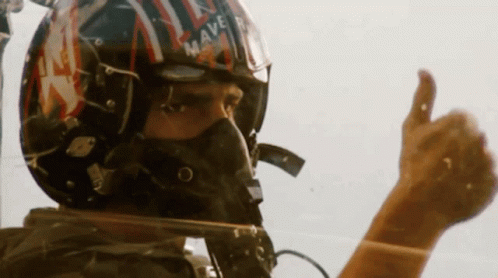 Man in Helmet and Mask Giving Thumbs Up