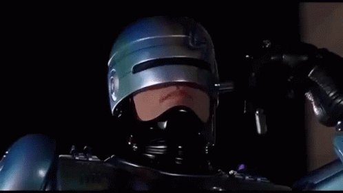 Man in Helmet and Mask Holding Gun Says We're Only Human