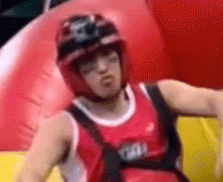 Man in Helmet and Red Tank Top on Red Inflatable Raft