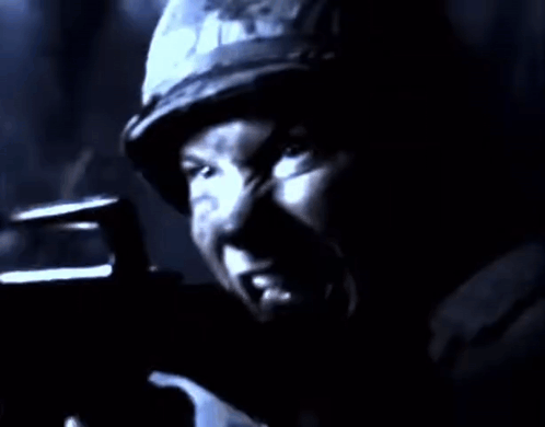 Man in Helmet Holding Gun