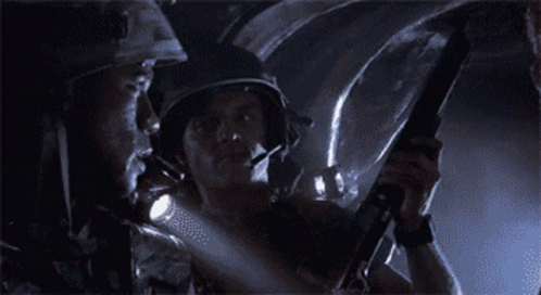 Man in Helmet Holding Gun