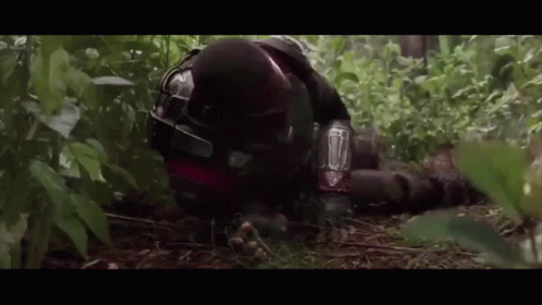 Man in Helmet Laying in Woods