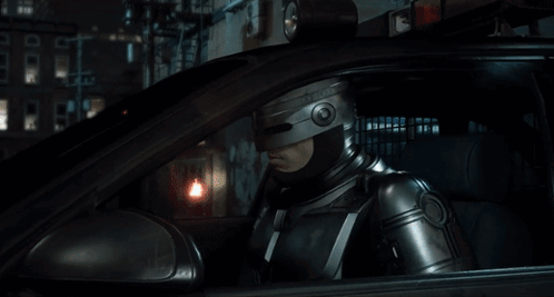 Man in Helmet Sitting in Car Looking Out Window