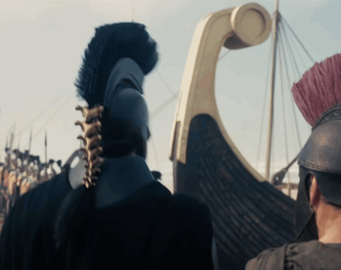 Man In Helmet With Feathered Crest In Front Of Boat GIF