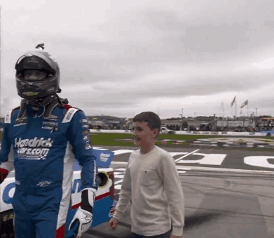 Man in Hendrick Cars.com Uniform Walking with Boy