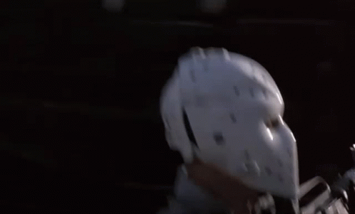 Man in Hockey Helmet Standing by Car