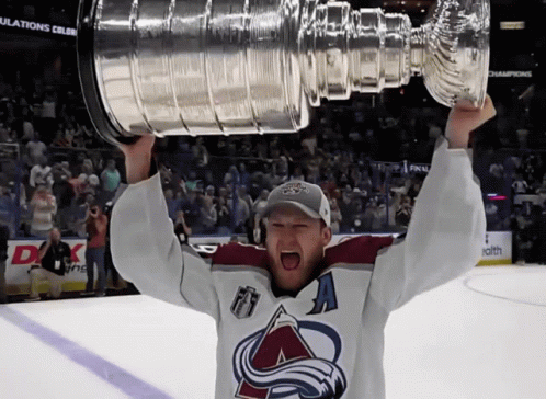 Man in Hockey Jersey Holding Trophy