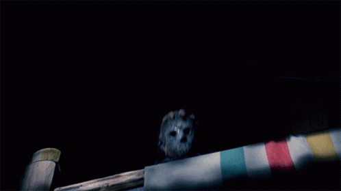Man in Hockey Mask Holding Knife in Dark