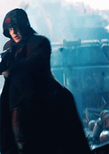 Man In Hooded Cape Holding Gun GIF