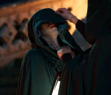 Man In Hooded Cape Holding Lantern Talking To Another Man GIF