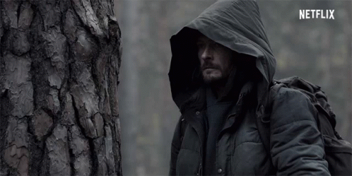 Man in Hooded Jacket Next to Tree with Netflix