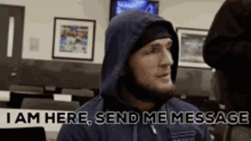 Man In Hooded Jacket Saying I Am Here Send Me Message GIF
